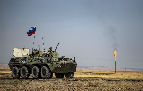 A Russian army vehicle, part of a patrol, drives past an oil field in the countryside of al-Qahtaniyah in Syria's al-Hasakeh province, on October 11. [Delil Souleiman/AFP]