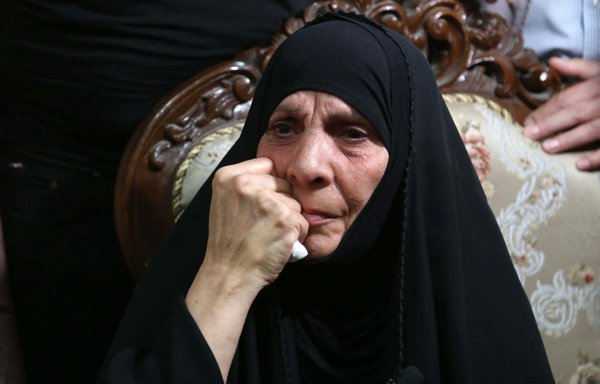 The mother of assassinated Iraqi activist Ihab Jawad al-Wazni reacts during the visit of a UN representative in her home in Karbala, on June 24. Her son was shot dead on May 9 by men on motorbikes using a silencer in an ambush outside his home. [Mohammed Sawaf/AFP]