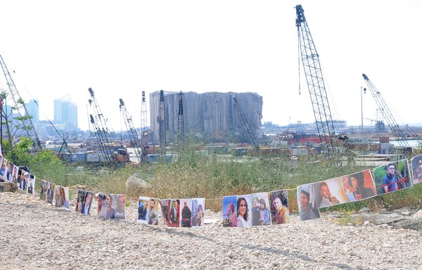 Photos of the victims of the Beirut port explosion are displayed in front of the port's main entrance on July 4. [Ziad Hatem]