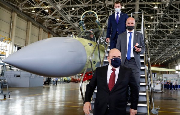 Russian Prime Minister Mikhail Mishustin (front) visits the Komsomolsk-on-Amur Aircraft Plant, which manufactures Sukhoi aircraft, in Komsomolsk-on-Amur on July 28. [Dmitry Astakhov/Sputnik/AFP]