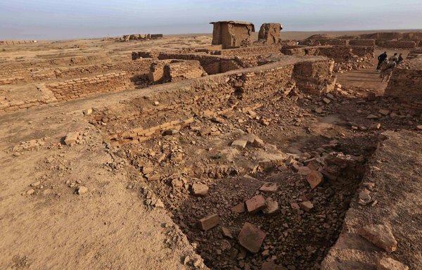 Iraqi soldiers stand amid destruction caused by ISIS at the archaeological site of Nimrud in Ninawa province, Iraq, on November 15, 2016, a few days after Iraqi forces retook the ancient city from the extremists. [Safin Hamed/AFP]