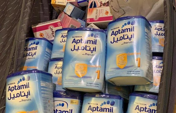 Baby formula donated by Lebanese expatriates to Hania Bissat can be seen in this photo, as part of her charity campaign 'On your way, a can of milk'. [Hania Bissat]