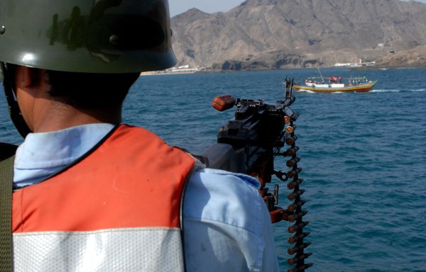 A member of the Yemeni coast guard mans a machine gun as a Yemeni fishing boat passes by during a patrol in the Gulf of Aden in a photo from October 20, 2008. [Khaled Fazaa/AFP]