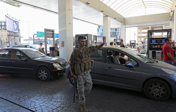 A Lebanese soldier directs traffic at a petrol station in Beirut on August 14, after soldiers were deployed to force several stations to reopen their doors. [Anwar Amro/AFP]