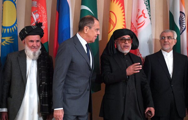 Russian Foreign Minister Sergey Lavrov, Taliban peace negotiator Sher Mohammad Abbas Stanekzai (centre) and then-Iranian Ambassador to Afghanistan Mohammad Reza Bahrami (right) pose for a photo in Moscow in November 2018. [Yuri Kadobnov/AFP]