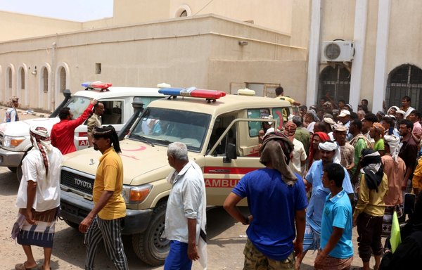 People gather as ambulances transport casualties of strikes on al-Anad air base to the Ibn Khaldun hospital in the government-held southern province of Lahj, on August 29. Houthi strikes on Yemen's largest air base killed at least 30 pro-government troops and wounded scores more. [Saleh Obaidi/AFP]