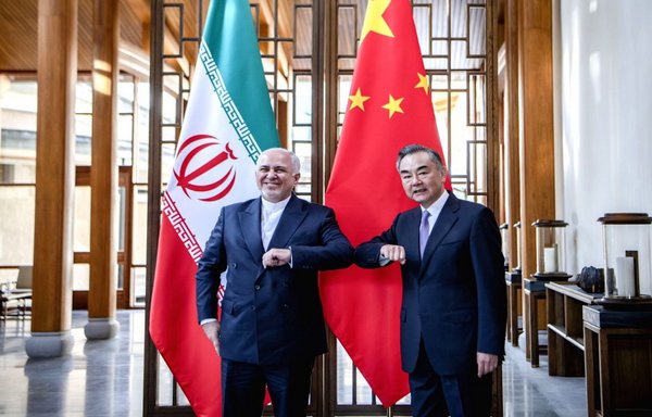 Then-Iranian Foreign Minister Javad Zarif poses with his Chinese counterpart, Wang Yi, last October 11 in Tengchong, China. [Chinese state media]