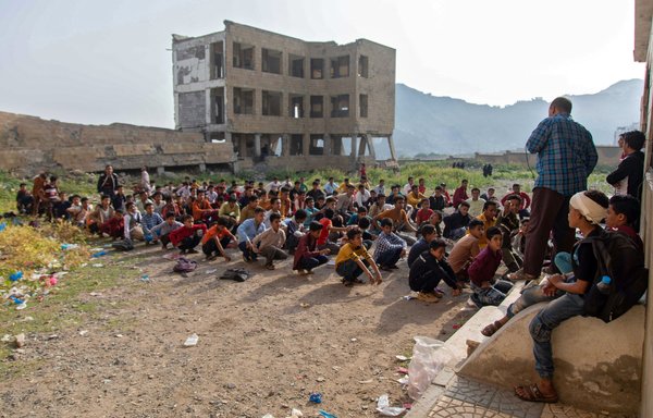 Yemeni students attend class in their destroyed school compound on the first day of the new academic year in the country's third city of Taez on August 30. [Ahmad al-Basha/AFP]