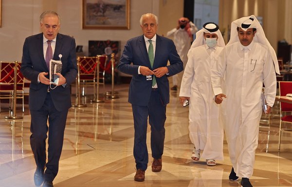 The United Nations Secretary General's personal envoy on Afghanistan Jean Arnault (left), US special envoy for Afghanistan Zalmay Khalilzad (centre) and Qatar's envoy on counter-terrorism Mutlaq al-Qahtani (right) walk through a hotel lobby in Qatar's capital Doha during an international meeting on the escalating conflict in Afghanistan August 12. [Karim Jaafar/AFP]