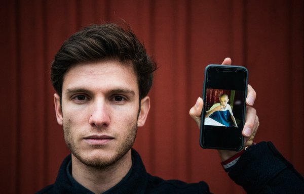 Omar Alshogre, a Syrian refugee who was tortured in Syrian prisons and is now director of Detainee Issues at the Syrian Emergency Task Force, shows a photo of him on a cellphone after he was released from prison, last November 11 in Stockholm, Sweden. [Jonathan Nackstrand/AFP]