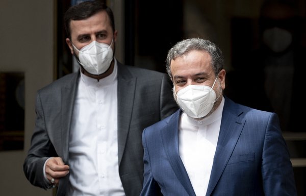 Kazem Gharib Abadi, Iran's governor to the International Atomic Energy Agency, and Abbas Araghchi, political deputy at the Iranian Foreign Ministry, leave the Grand Hotel Wien after closed-door nuclear talks in Vienna on June 20, where diplomats of Britain, the EU, China, Russia and Iran held their talks. [Joe Klamar/AFP]