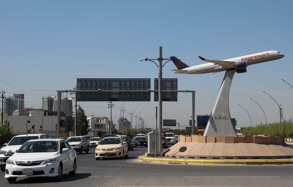 The model of an aeroplane of Iraqi Kurdish carrier Zagrosjet decorates the centre of a roundabout near Erbil's International airport in the capital of Iraq's Kurdish region on April 15. [Safin Hamed/AFP]