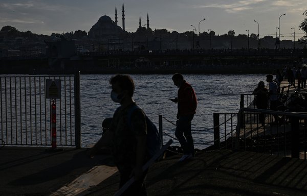 People walk on the Bosporus in Istanbul, Turkey, on September 13. [Ozan Kose/AFP]
