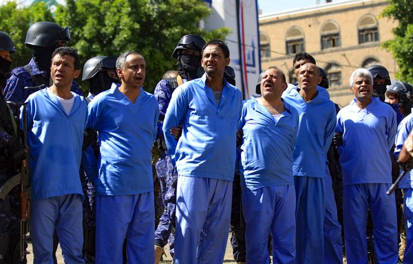Defendants are lined up before their execution by a Houthi firing squad in a public square in Sanaa on September 18. [Mohammed Huwais/AFP]