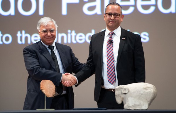Iraqi Ambassador to the US Fareed Yasseen (L) shakes hands with Steve Francis, Executive Associate Director of US Homeland Security Investigations at the Smithsonian National Museum of the American Indian, in Washington DC, September 23, following the official handover of the Gilgamesh Tablet back to Iraq. [Saul Loeb/AFP]