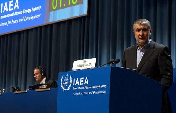 Atomic Energy Organisation of Iran director Mohammad Eslami (right) delivers a speech as IAEA director-general Rafael Grossi listens during the IAEA General Conference, an annual meeting of all the IAEA member states, at the agency's headquarters in Vienna, Austria, on September 20. [Joe Klamar/AFP]