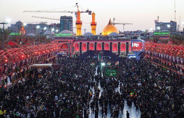 Shia pilgrims gather at the shrine of Imam al-Abbas in the holy city of Karbala on September 25, ahead of Arbaeen. [Mohammed Sawaf/AFP]