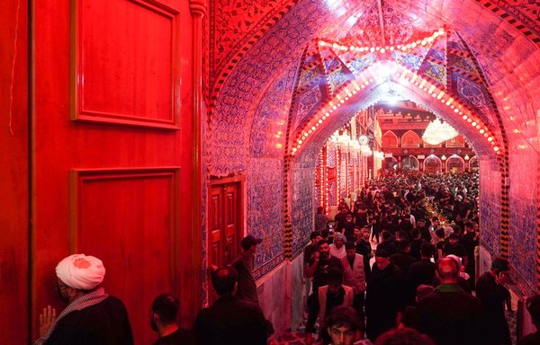 Shia pilgrims gather at the shrine of Imam al-Abbas in Karbala, on September 25, ahead of Arbaeen. [Mohammed Sawaf/AFP]