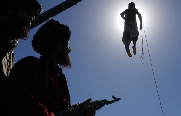 A man's body hangs from a crane in Herat city September 25 after the Taliban killed four alleged kidnappers during a shootout and hung their corpses later. [Emran/Salaam Times]