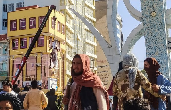 A dead body displayed on a crane in Herat on September 25. [AFP]