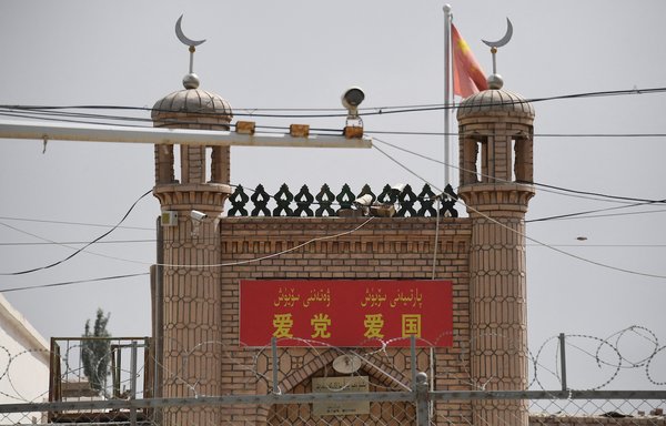 Surveillance cameras and barbed wire surround the Jieleixi No. 13 village mosque in Yangisar, Xinjiang region, on June 4, 2019. Beijing is damaging or destroying thousands of mosques in Xinjiang and across the country as part of its 'sinicisation' campaign designed to pressure Muslims, including Uighurs and other ethnic minorities, to become more 'Chinese'. [Greg Baker/AFP]