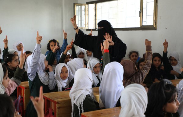 Yemeni girls attend class on the second day of the new school year in Sanaa, on August 15. A recent report documents the Houthis' mistreatment of women since the beginning of the war. [Mohammed Huwais/AFP]