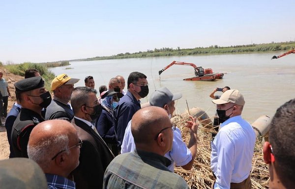 Iraqi officials check on the progress of the Khurasan River clean-up project in Diyala province on August 21. The project aims to reduce water loss and alleviate the drought. [Iraqi Ministry of Water Resources]