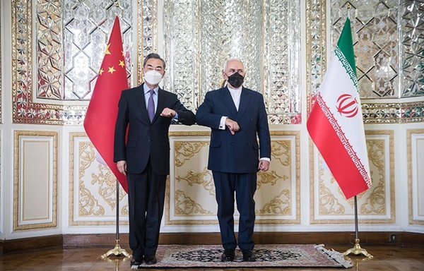 Chinese and Iranian foreign ministers pose for a photograph together in Tehran after signing a 25-year agreement between their countries. [Tasnim News]