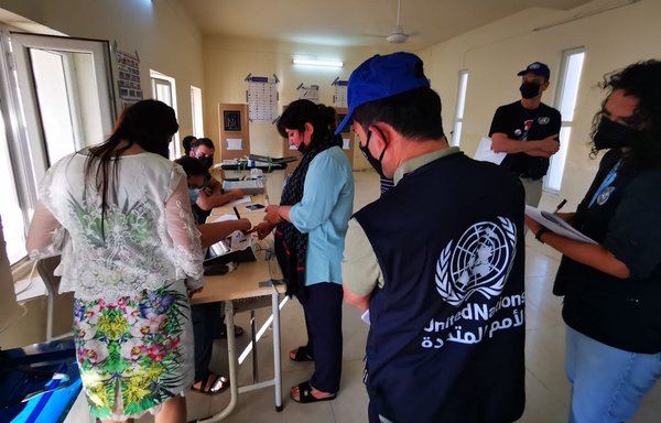 An employee of the United Nations Assistance Mission for Iraq monitors the voting process at a polling station in Erbil province, northern Iraq, on October 10. [The United Nations Mission in Iraq]
