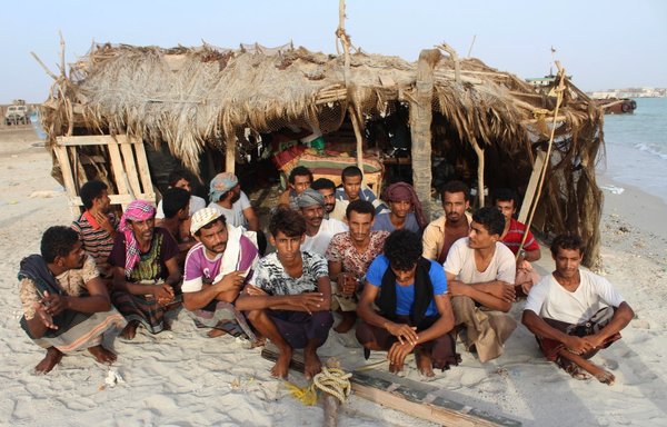 A picture taken June 3, 2018, shows detained Houthi fighters at a coast guard base near the Yemeni port of Mokha on the Red Sea coast. [Saleh al-Obeidi/AFP]