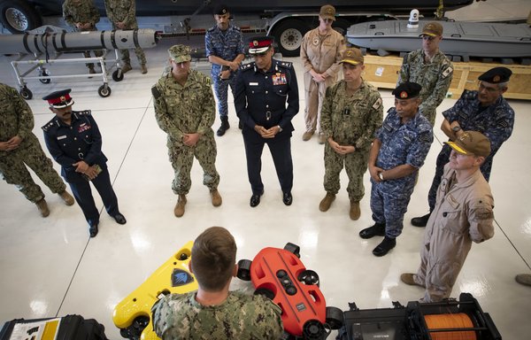 US 5th Fleet commander Vice Adm. Brad Cooper (centre right), Maj. Gen. Ala Abdulla Seyadi, commander of the Bahrain Coast Guard (centre left), and Rear Adm. Mohammed Yousif Al Asam, commander of the Royal Bahrain Naval Force (right), listen to a presentation on remotely operated unmanned underwater vehicles. [US Navy]
