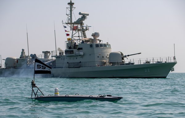 A MANTAS T-12 unmanned surface vessel operates alongside Royal Bahrain Naval Force fast-attack craft RBNS Abdul Rahman al-Fadel during the New Horizon drill in the Arabian Gulf on October 26. [US Navy]