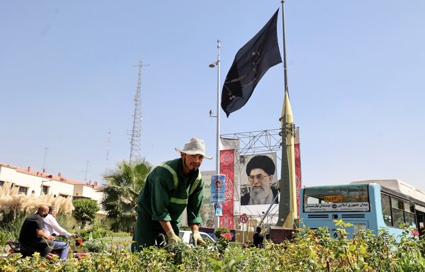 A Shahab-3 surface-to-surface missile is displayed next to a portrait of Iranian leader Ali Khamenei at an IRGC street exhibition to celebrate 'Defence Week' in Tehran on September 25. [Atta Kenare/AFP]