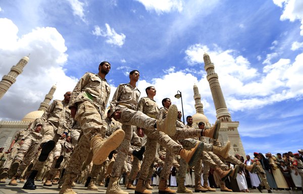 Houthi forces march in Yemen's capital Sanaa on April 27. [Mohammed Huwais/AFP]