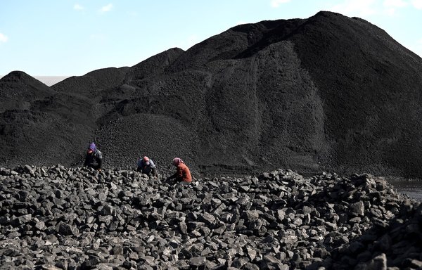 Workers sort coal near a mine in Datong, Shanxi province, on November 3. China's National Mine Safety Administration on October 21 said 10 accidents killed 18 workers in the preceding four weeks, mostly in coal mines. [Noel Celis/AFP]