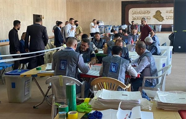 Officials of the Iraqi Independent High Electoral Commission count ballots by hand on October 27 at the request of the parties and the leaders of the militias that were defeated in the electoral race. [IHEC]