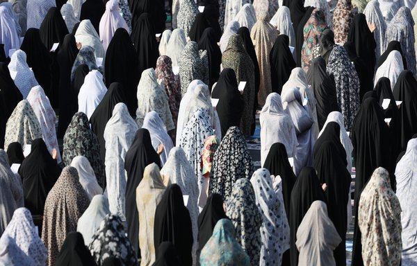 Iranian women perform the morning prayer on the first day of Eid al-Fitr in Tehran on May 13. [Atta Kenare/AFP]