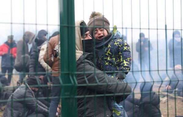 Migrants gather on the Belarusian-Polish border on November 15. Thousands of migrants -- most of them from the Middle East -- have crossed or attempted to cross the EU and NATO border since the summer. [Oksana Manchuk/BELTA/AFP]