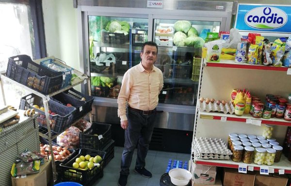 Habib Abdel Massih stands in his rehabilitated mini mart in the Gemmayzeh area, which he was able to reopen after receiving in-kind assistance from USAID. [Habib Abdel Masih]