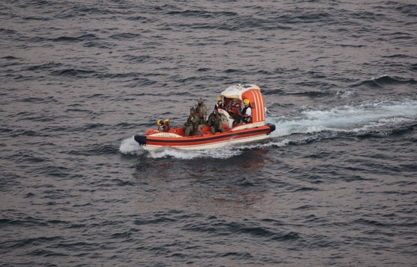 Personnel from dry cargo ship USNS Charles Drew transport an Iranian mariner November 27 in the Gulf of Oman. Two Iranian mariners requested assistance after their fishing vessel was adrift at sea for eight days. [US Navy]