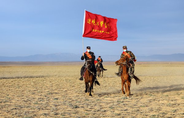 This photo taken on April 22 shows police officers and a staff member riding horses as they prepare to publicise laws and government policy to nomad herders in a remote area in Altay in China's northwestern Xinjiang region. [STR/AFP]