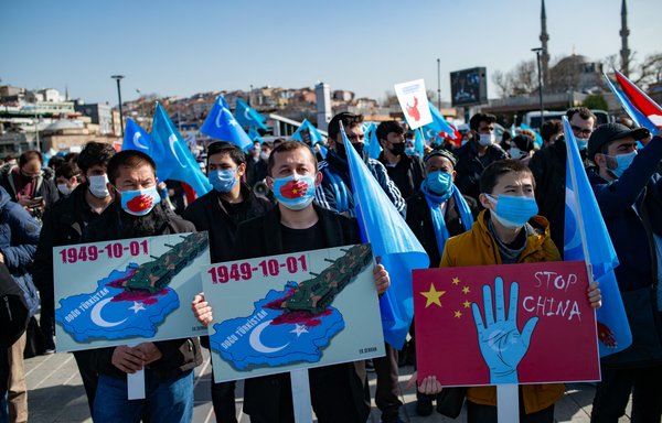 Uighurs and other Muslims rally in Istanbul in February, demanding justice for the crimes being committed in Xinjiang. [Yasin Akgul/AFP]