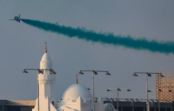 A jet releases smoke as it performs an air display over the Jeddah Corniche Circuit ahead of the Formula One Saudi Arabian Grand Prix in Jeddah on December 5. [Giuseppe Cacace/AFP]