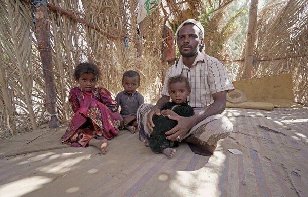 Ali Yehya Hayba and his children, who fled fighting between the Houthis and the Yemeni forces, are seen here on November 24 at al-Sumya displacement camp east of Marib city, the last remaining government stronghold in northern Yemen. [AFP]