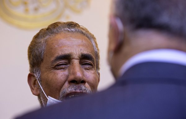 Mohammed al-Haris, father of Salim al-Haris, one of the victims of a motorcycle bomb that exploded the day before, reacts as he is visited by Iraqi Prime Minister Mustafa Kadhemi during his son's memorial service in the southern city of Basra on December 8. [Hussein Faleh/AFP]