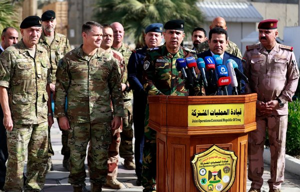 Iraqi interior ministry spokesman Maj. Gen. Saad Maan (centre) gives a press conference, accompanied by Iraqi National Security Adviser Qassem al-Araji (centre right), NATO Mission Iraq Commander Lt. Gen. Michael Lollesgaard (left), and Commander of the US-led international coalition Maj. Gen. John W. Brennan (centre left), after a meeting with coalition commanders at the Joint Operations Centre in Baghdad's Green Zone on December 9. [Ahmad al-Rubaye/AFP]