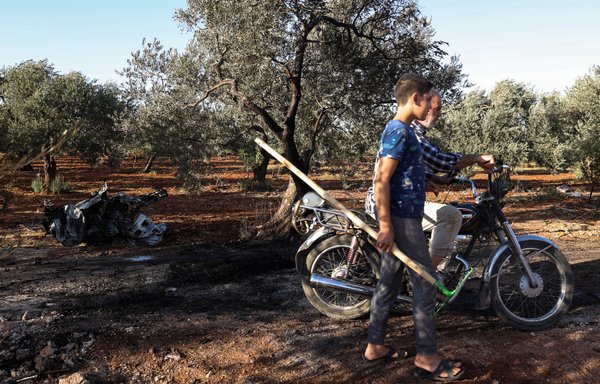This picture taken on September 20 shows a vehicle destroyed by what is believed to be a drone strike, on the northeastern outskirts of Idlib, Syria. A separate drone strike on December 3 killed an al-Qaeda leader, according to the Pentagon. [Omar Haj Kadour/AFP]