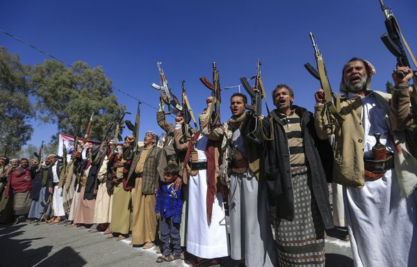 Supporters of Yemen's Houthis raise firearms as they chant slogans during a demonstration in Sanaa on January 18. [Mohammed Huwais/AFP]