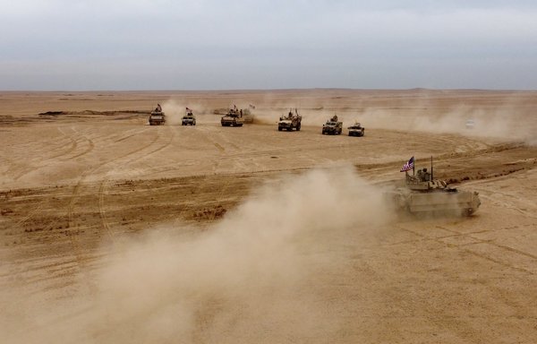 This picture taken December 7 shows an aerial view of US Bradley Fighting Vehicles during a joint military exercise between the Syrian Democratic Forces and the international coalition against ISIS in rural Deir Ezzor. [Delil Souleiman/AFP]