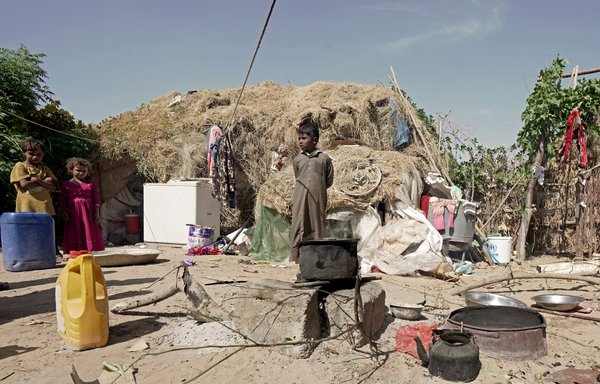 Children stand outside a tent at the al-Sumya camp for internally displaced persons (IDPs) east of Marib city on November 24. [AFP]